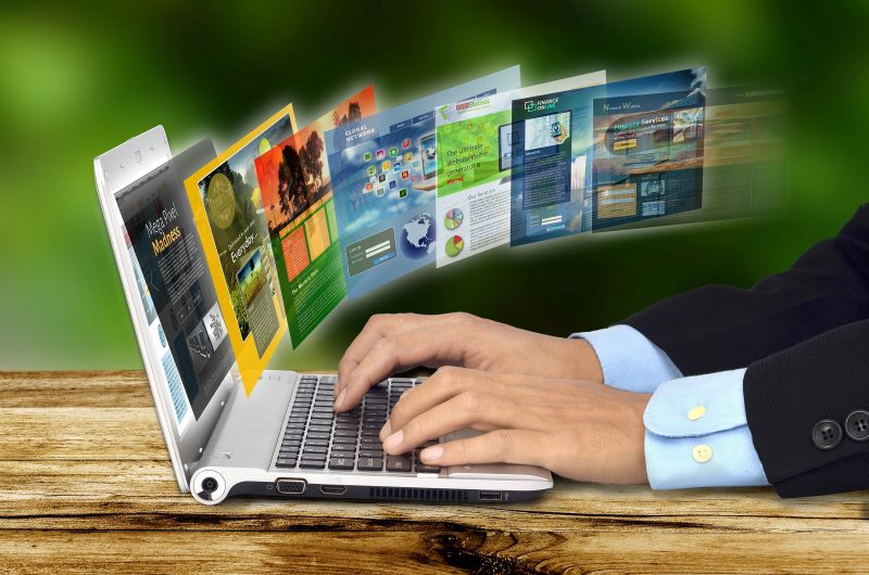 Businessman hand browsing internet websites on his laptop