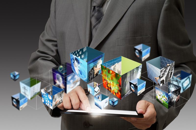 business hand holding a touch pad computer and 3d streaming images