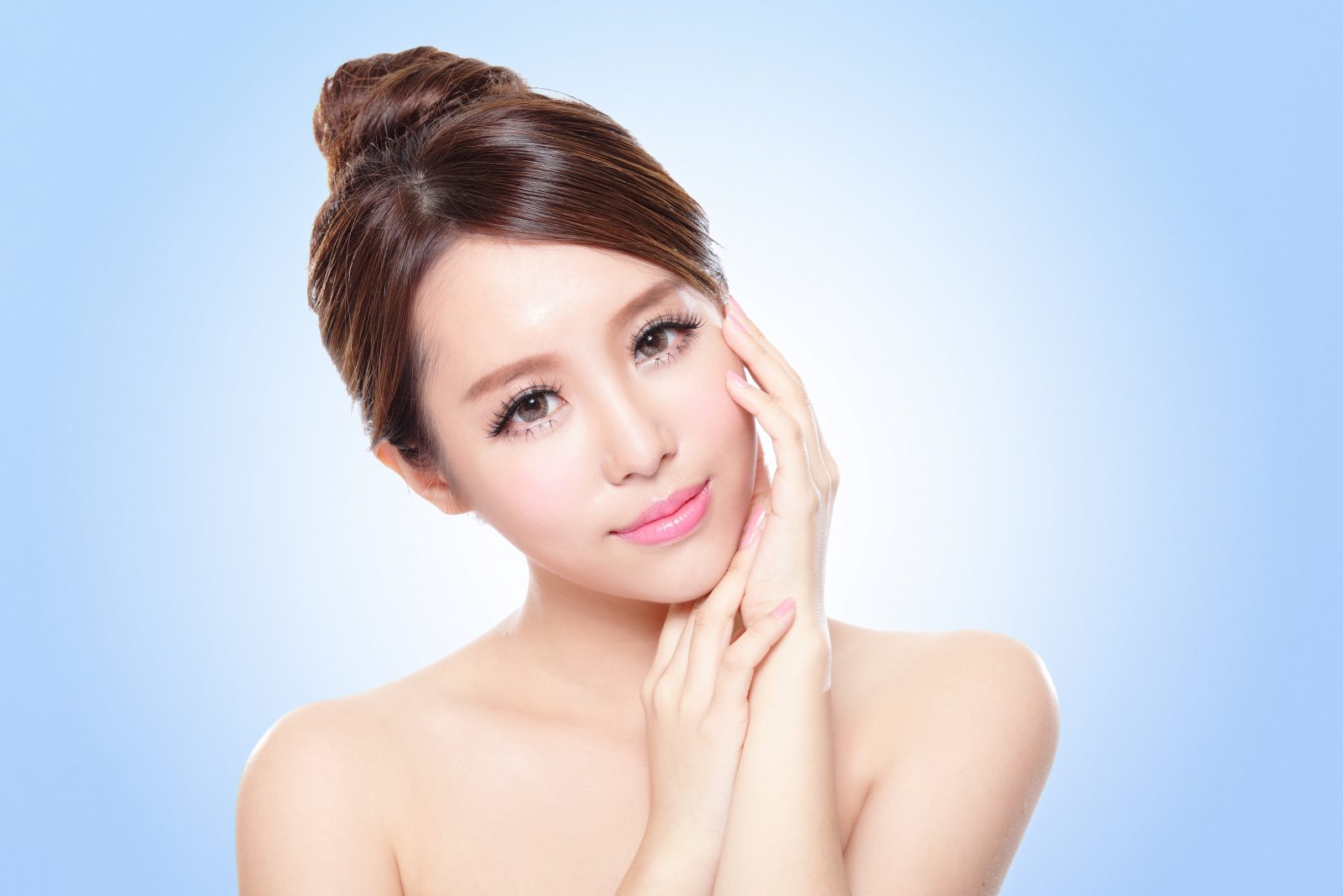 close up of attractive asian woman face with blue background